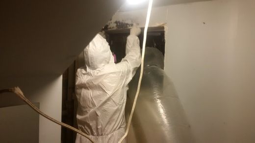 Professional installing asbestos moulding 